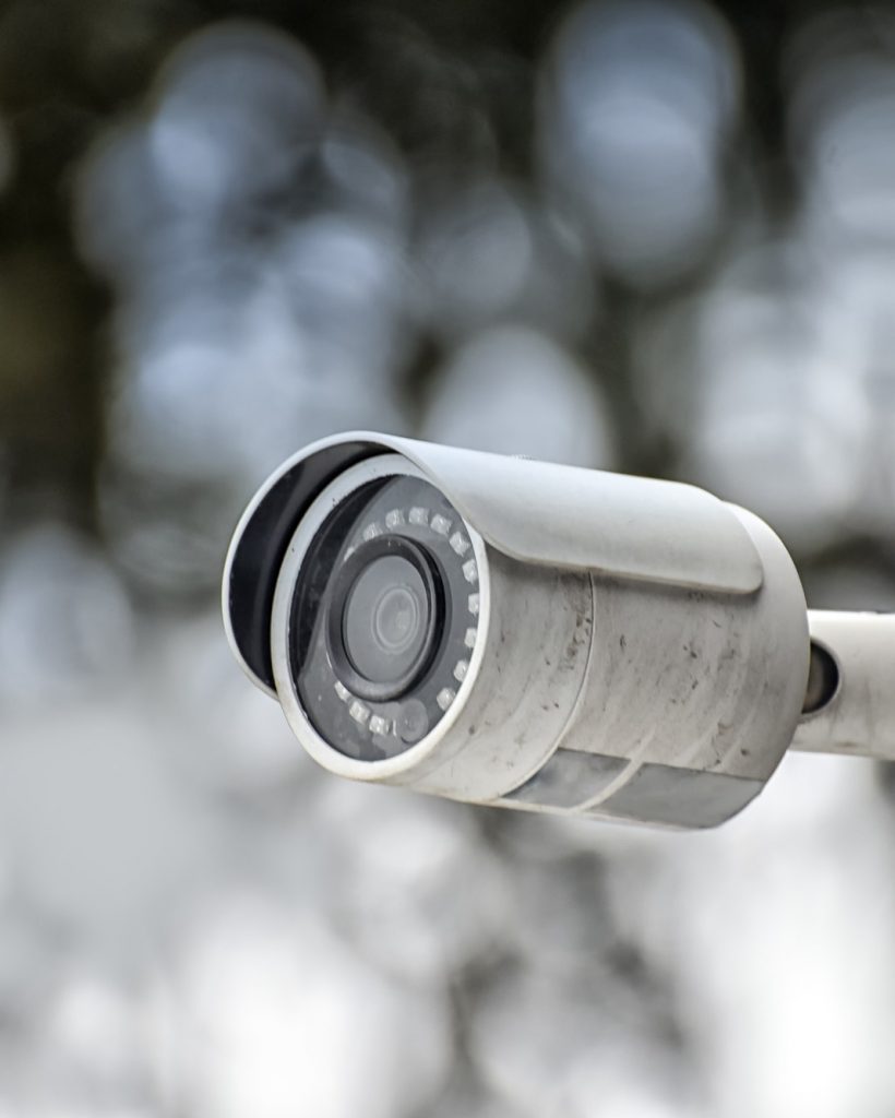 Security system of outdoor video surveillance, CCTV Security Camera on blurred outdoors background.